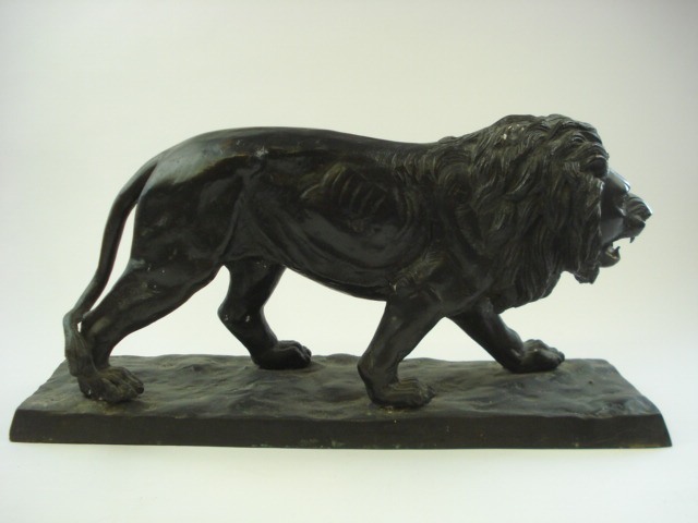 A spelter figure of a lion:, on a rectangular naturalistic base, unsigned, 24cm high.