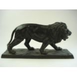 A spelter figure of a lion:, on a rectangular naturalistic base, unsigned, 24cm high.