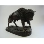 After Leon Mignon, a bronzed spelter figure of a Bison:, standing on a naturalistic base, 33cm high.