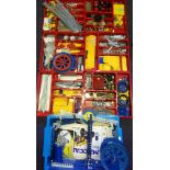 Meccano: an extensive collection of parts including base plates, spans, spars, wheels, gears, rods,