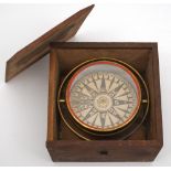 A 4 1/2 inch dry card compass:, unsigned, in a gilt brass gimbal in an oak case,