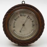 A circular oak cased compensated aneroid barometer by Short & Mason Ltd, London:,