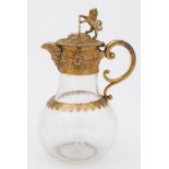 A Victorian glass and gilt metal mounted claret jug: of baluster form,