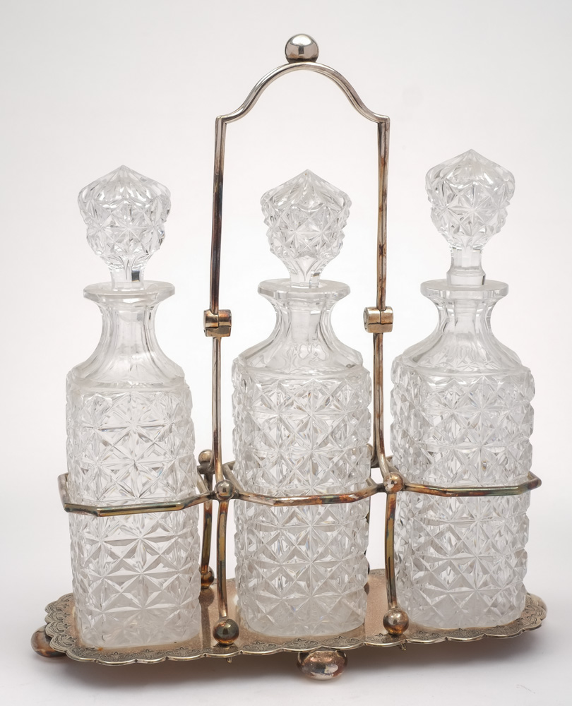 A silver plated three-division decanter stand by Walker & Hall: of rectangular outline,