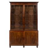 An early 19th Century mahogany library bookcase:, the upper part with a moulded cornice,