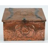 An Art Nouveau period copper coal box: the sloping hinged fall with stylised flower and strap work