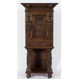 A 19th Century carved oak upright cabinet on a stand:, with applied earlier pieces of woodwork,