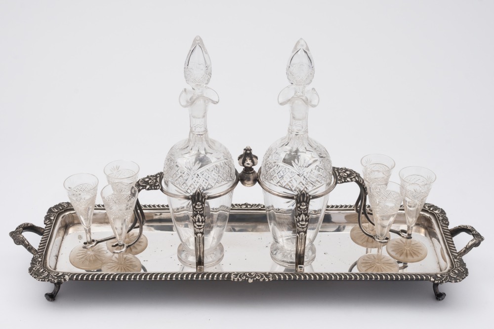 A late Victorian plated decanter stand: of rectangular outline, with gadrooned border,