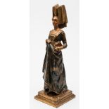 A carved wooden and polychrome decorated figure of a lady: wearing medieval costume with V-shaped