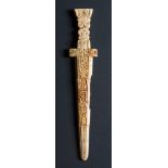 A Chinese archaic-style stone dagger pendant: carved with taotie masks and scrollwork,