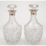 A pair of Elizabeth II silver mounted clear glass decanters and stoppers, maker Roberts & Dore Ltd,