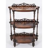 A Victorian walnut serpentine fronted three tier whatnot:,