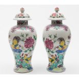 A pair of Chinese famille rose baluster vases and covers: painted with cockerels,