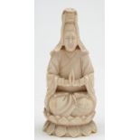A 19th century Chinese carved ivory figure: possibly Guanyin, seated cross legged on a lotus flower,