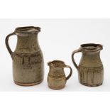 Richard Batterham (born 1936) a graduated garniture of three stoneware jugs: of tapering form with