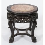 A Chinese carved hardwood circular jardiniere stand: the lobed top with a beaded edge,