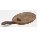 By Robert Thompson of Kilburn 'The Mouseman' an oak cheese platter: of oval outline with swept