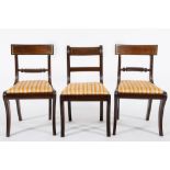 A set of six Regency mahogany dining chairs:, including two elbow chairs,