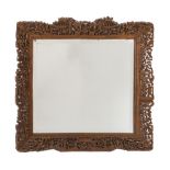 A Chinese carved wood rectangular mirror:, with inset bevelled plate,