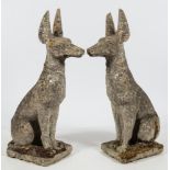 A pair of reconstituted stone figures of Egyptian hunting dogs:,