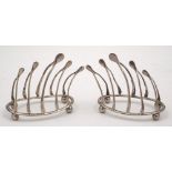 A pair of Edward VII silver four-division wishbone toast racks, maker William Hutton & Sons,