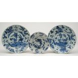 Three blue and white plates: comprising a pair of shallow circular form the centre painted with