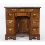 An 18th Century walnut and feather banded kneehole desk:, of small size,