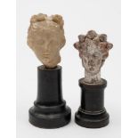 A small carved marble head: mounted on an ebonised stand, 10.5cm.