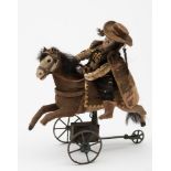 A late 19th/20th Century French clockwork horse and rider:.