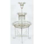 A painted wirework circular graduated three tier conservatory plant stand:, in the Victorian manner,