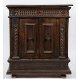 A late 17th/early 18th Century Italian walnut dwarf side cupboard:, the top with a moulded edge,