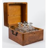 A 19th century French decanter set in marquetry case: with inlaid floral decoration to the top and