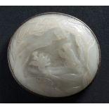 A Chinese jade oval plaque: carved with a figure paddling a boat within a lake landscape,