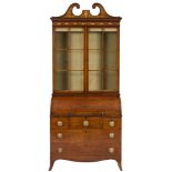 An early 19th Century mahogany, satinwood decorated and inlaid cylinder fronted bureau bookcase:,