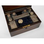 A Victorian rosewood lady's vanity case for Asprey: the rectangular case with brass stringing,