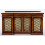 An early Victorian mahogany sideboard:, of recessed breakfront outline, having a later ledge back,