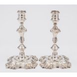 A pair of George II cast silver candlesticks, maker William Cafe, London, 1758: crested,