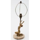 An Art Deco period table lamp: decorated with a kneeling figure of a woman wearing vest and skirt,