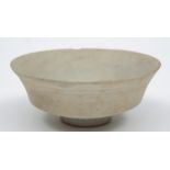 A Chinese pottery bowl: of footed shallow circular form under pale celadon glazes, 12 cm diameter,