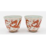 A pair of Chinese porcelain wine cups: of thinly potted form the exterior of each painted in copper
