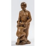 A carved olivewood figure group: mother and child,