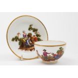 A Zurich cup and saucer: painted with landscape vignettes of rustic figures around a basket,