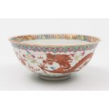 A Chinese famille rose dragon and phoenix bowl: painted with a dragon and a phoenix persuing a