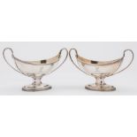 A pair of George III silver pedestal salts.