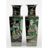 A pair of Chinese porcelain famille noire vases: of shouldered square form with raised flaring neck,