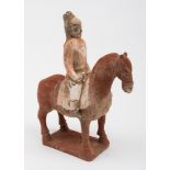 A Chinese painted pottery horse and rider: cold painted in red and grey pigments,