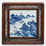 A Chinese blue and white porcelain and hardwood table screen: the square porcelain panel painted