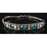 A silver and blue and white zircon thirteen-stone bracelet: with oval blue zircons between pairs of