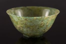 A Chinese spinach green jade bowl: with flared rim and short foot rim, the stone of mottled green,