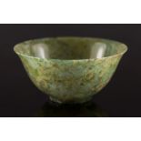 A Chinese spinach green jade bowl: with flared rim and short foot rim, the stone of mottled green,